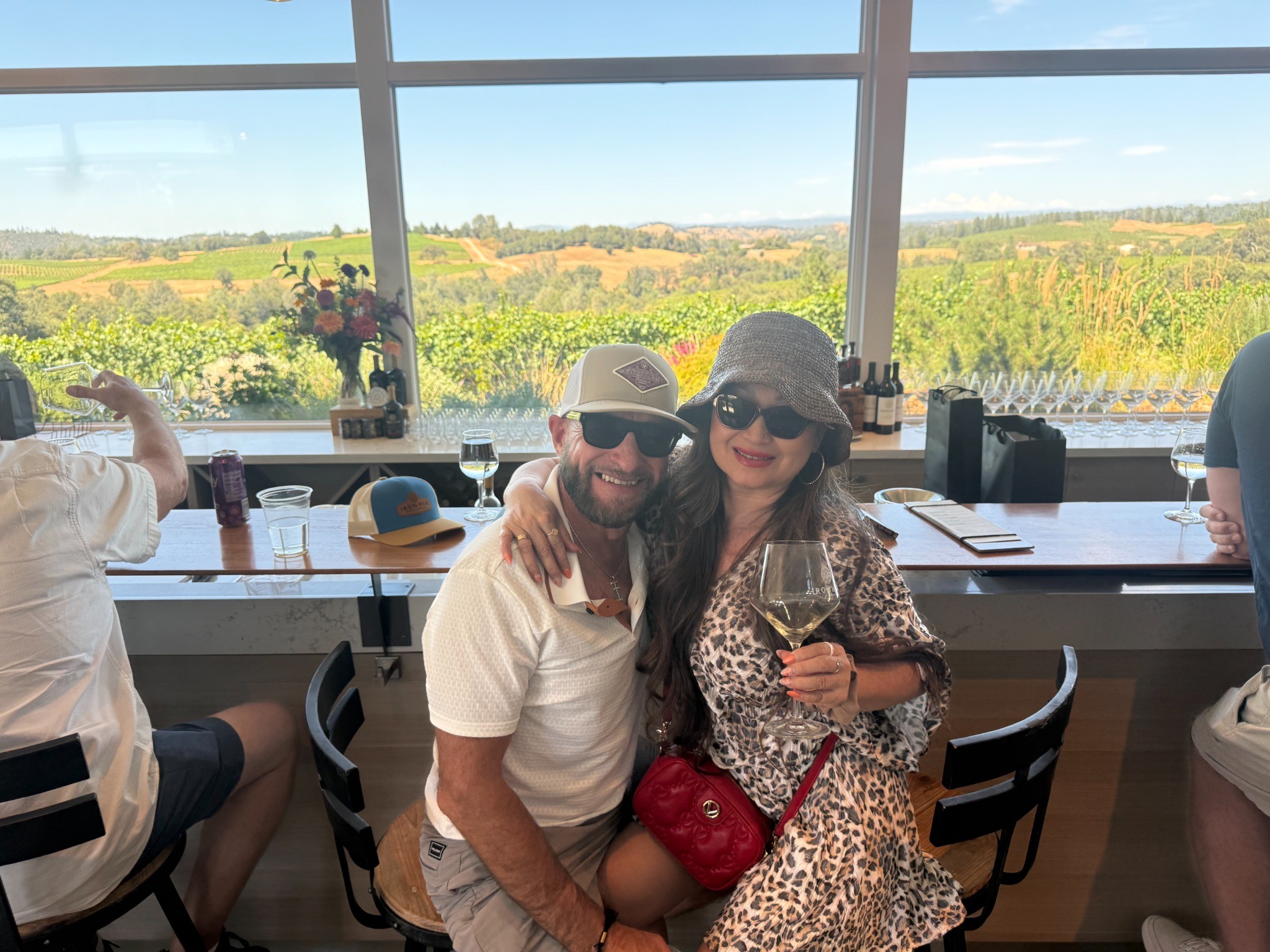 Guests enjoying a second winery tasting with vineyard views in Amador