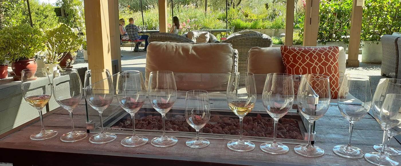 Wine glasses on a fire pit table at an outdoor winery patio — NapSac Wine Tours