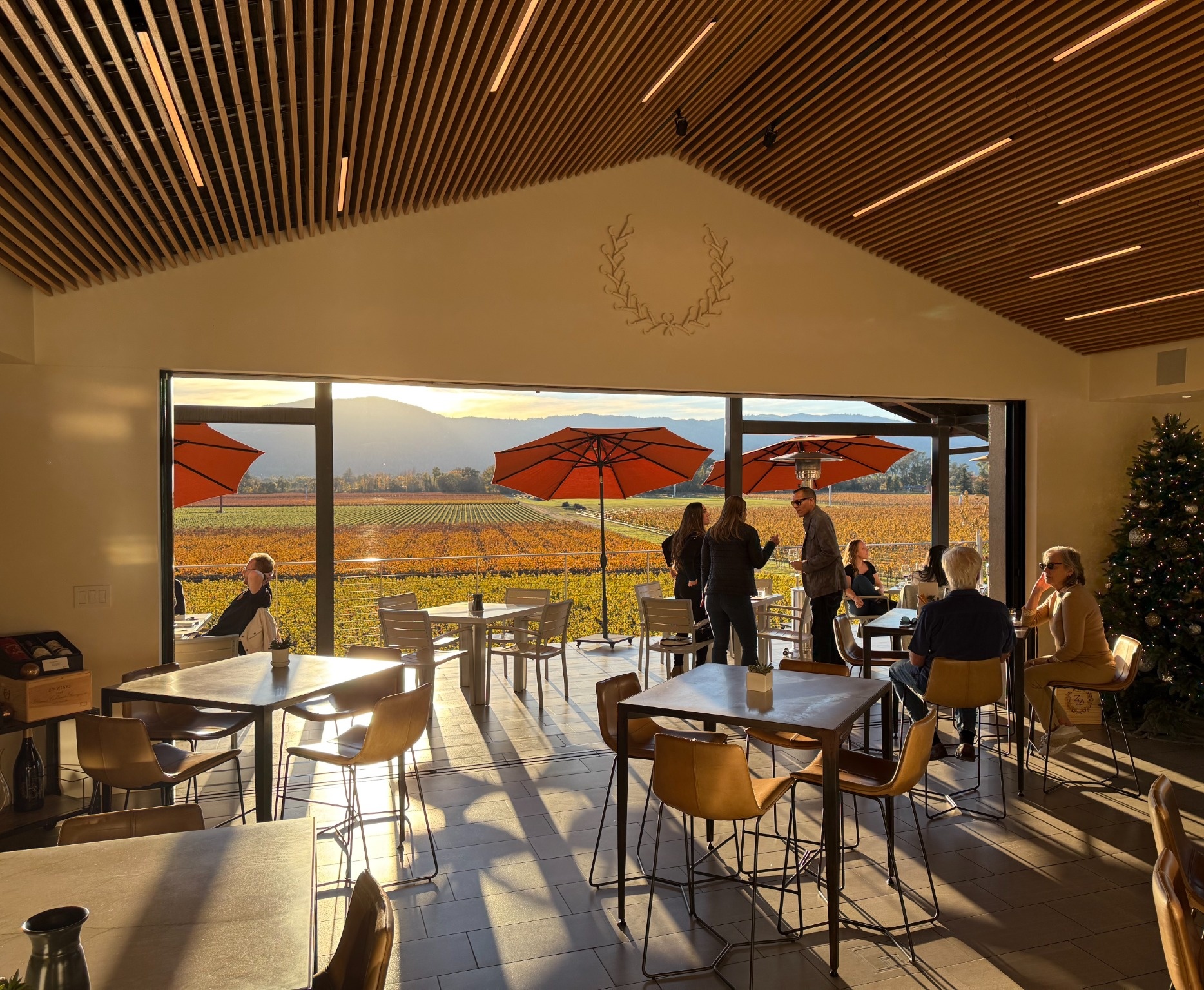 Indoor tasting room overlooking Napa vineyards at sunset